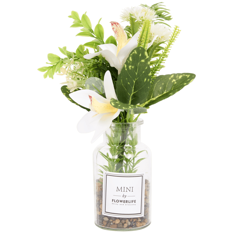 Fleurs artificielles dans vase en verre